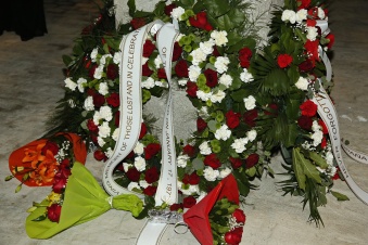 Wreath from the family of LCPL Michael T Gurney (USS Guam) with flowers from the family of PFC Raul Cantú